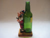 Vintage quirky fun bottle with figurine of a Scottish Bagpipe player (Angus MacFlasher) in front of the bottle