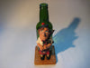 Vintage quirky fun bottle with figurine of a Scottish Bagpipe player (Angus MacFlasher) in front of the bottle