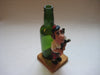 Vintage quirky fun bottle with figurine of a Scottish Bagpipe player (Angus MacFlasher) in front of the bottle