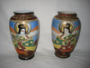 A pair of hand painted Japanese ceramic vases