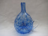 Bottle with a handle in clear glass with streaks of blue