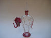 Perfume bottle in clear and maroon colour glass with gold trimmings in the shape of an elephant