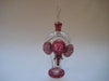 Perfume bottle in clear and maroon colour glass with gold trimmings in the shape of an elephant