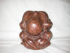 Wooden sculpture of a man in sitting position