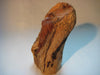 A bust (sculpture) of a woman carved out of a log