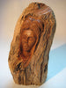 A bust (sculpture) of a woman carved out of a log