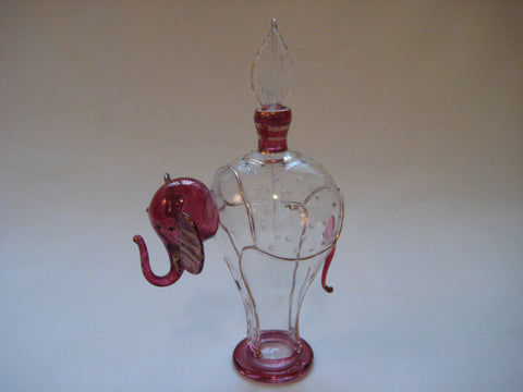 Perfume bottle in clear and maroon colour glass with gold trimmings in the shape of an elephant