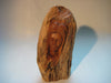 A bust (sculpture) of a woman carved out of a log